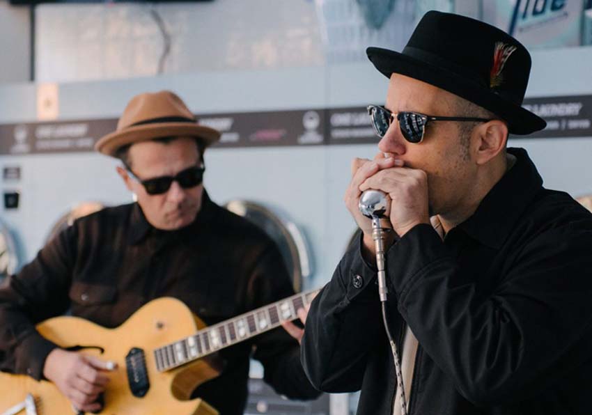 event image:Two musicians, one with a guitar and the other singing
